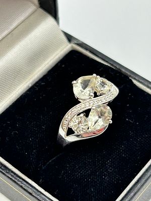 A silver multi-stone Toi et Moi style bypass cocktail ring