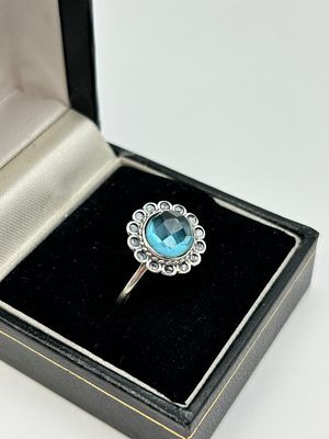 A Silver Cocktail Ring Set with a Swiss Blue Topaz