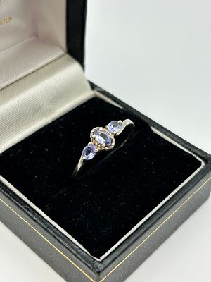 A Silver Three Stone Trilogy Ring Set with Violet Blue Stones