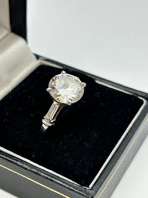 A silver three stone cocktail ring