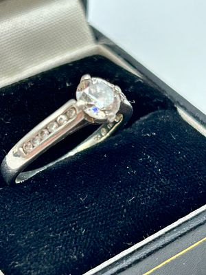 A silver multi-stone engagement style ring