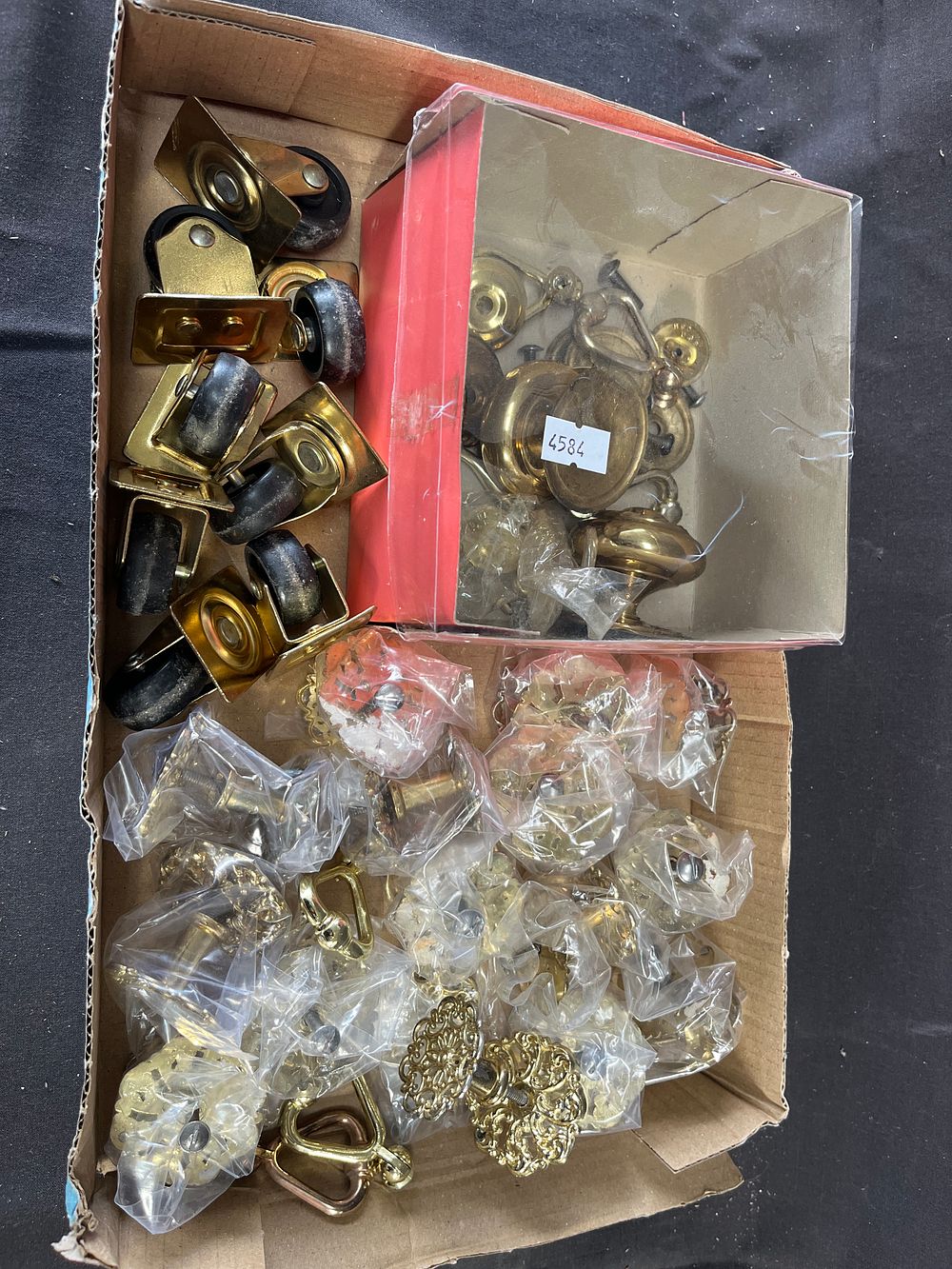 Lot 351: An Assortment of Vintage and Antique Brass Furniture Hardware, Including Drawer Pulls, Knobs, and Casters