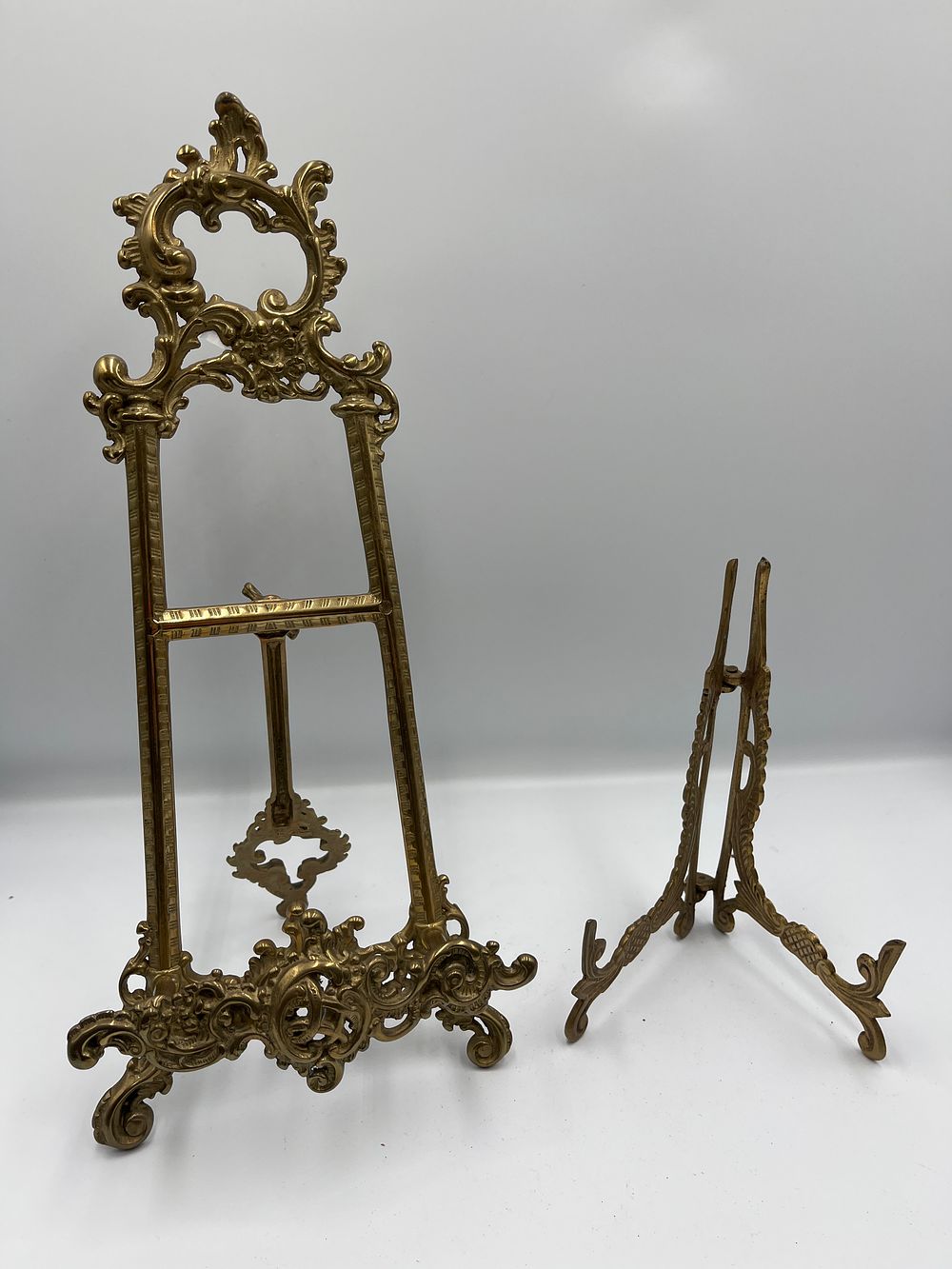 Lot 1085: A Pair of Rococo Revival Style Cast Brass Display Easels of Graduated Size