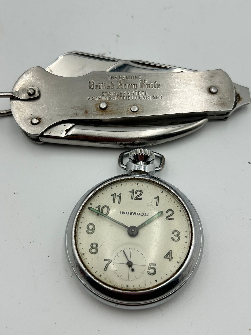Lot 424: Two items comprising an Ingersoll pocket watch and a Sheffield British Army multi-tool pocket knife