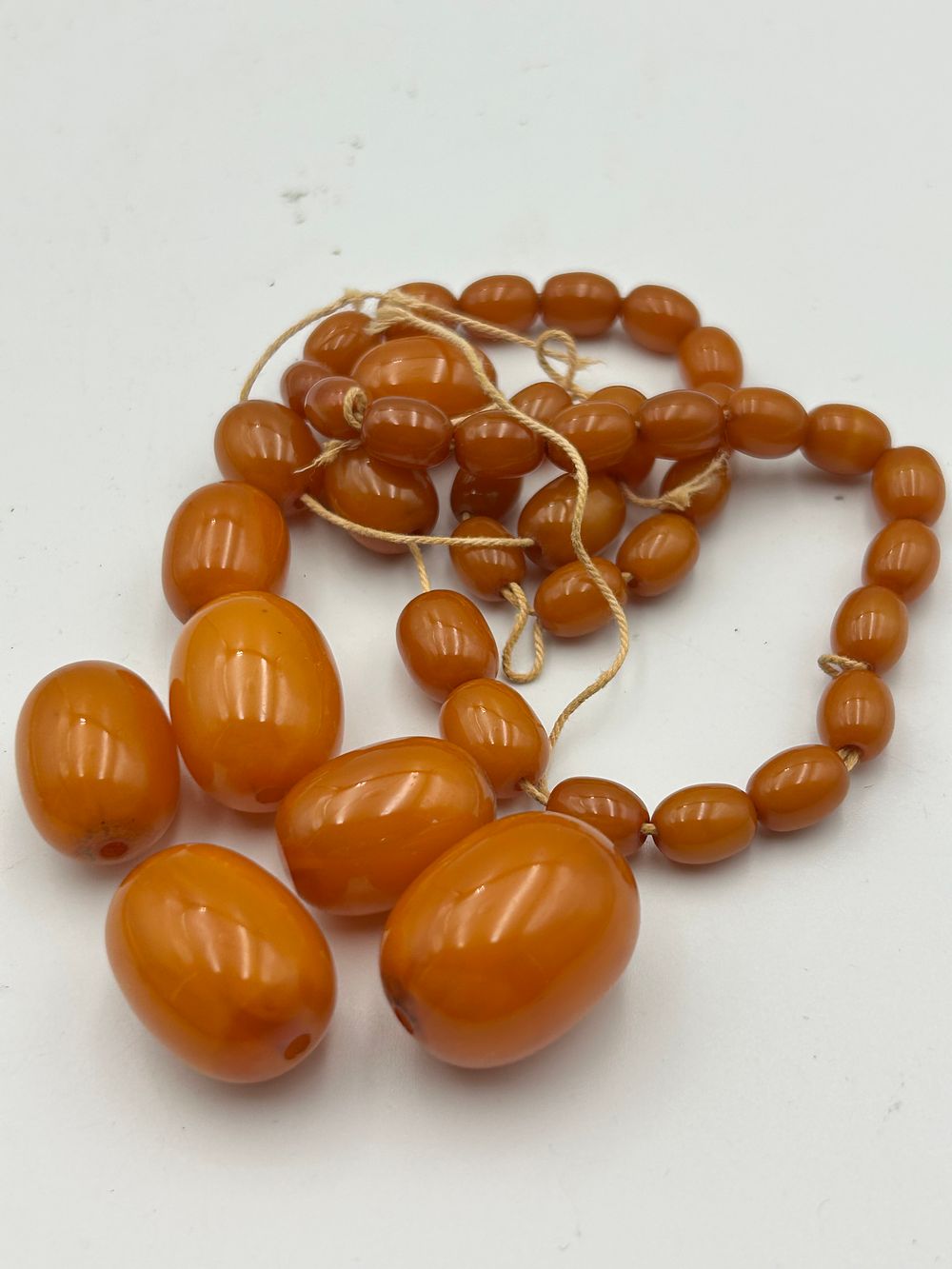 Lot 435: A Graduated Art Deco Style Baltic Butterscotch Amber? Bead Necklace