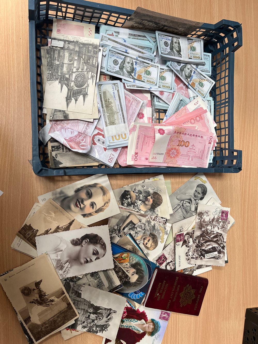 Lot 542: An Assortment of Vintage Postcards, Prop Currency, and a Fire Services Benevolent Fund Notebook
