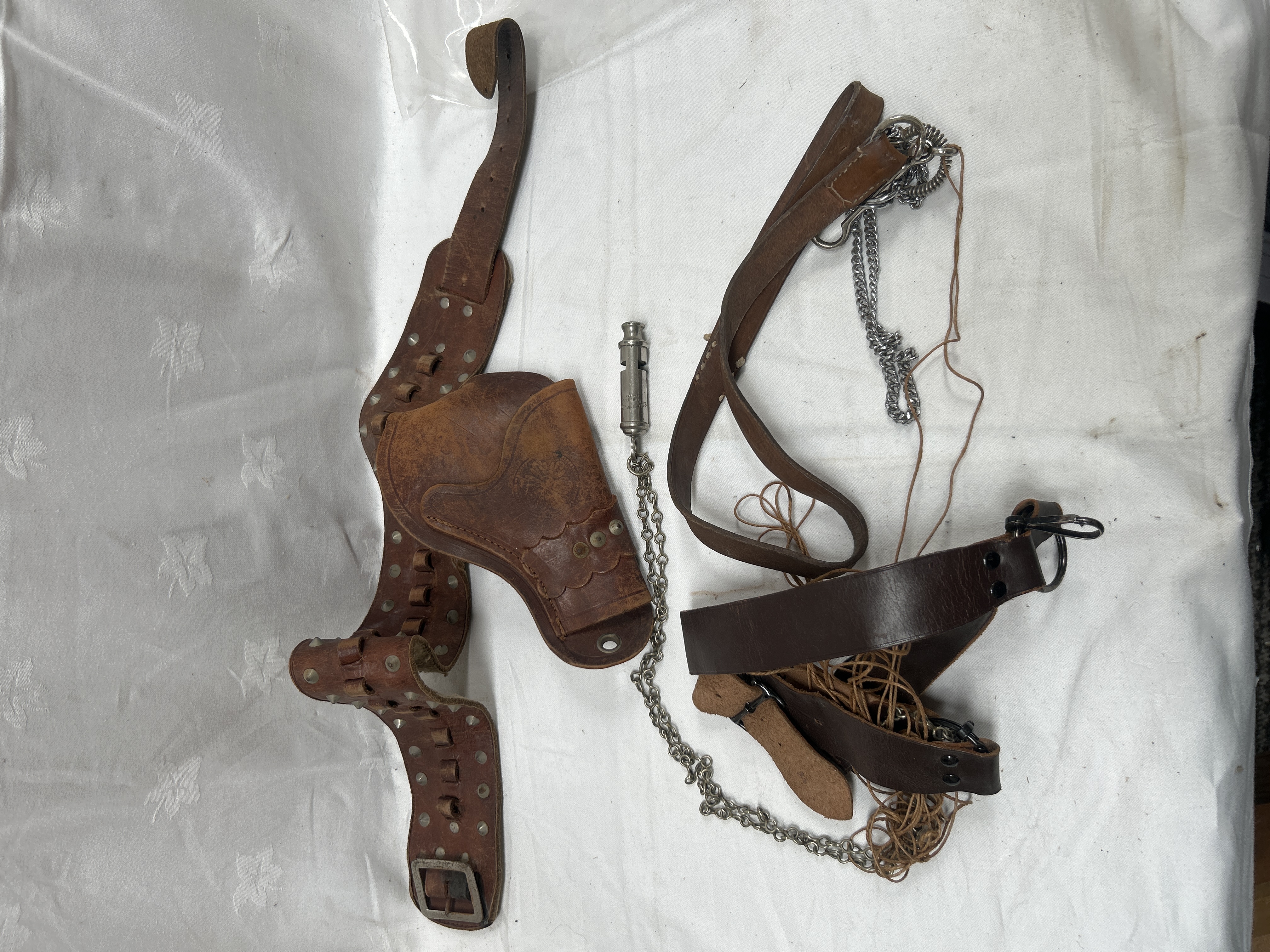 An Assortment of Vintage Western-Style Leather Holster Equipment and an Acme City Whistle