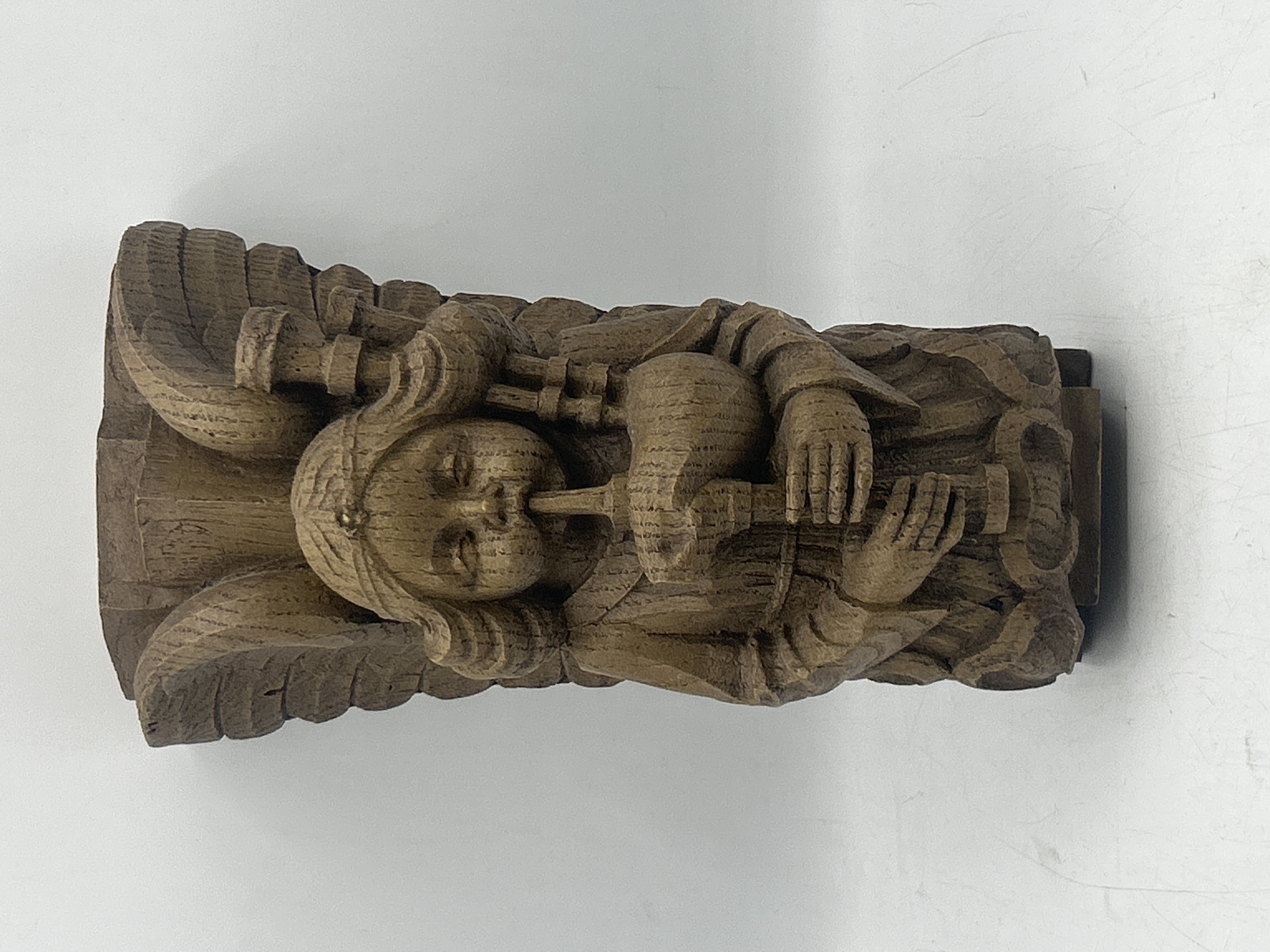 Carved Oak Corbel of an Angel Playing Bagpipes