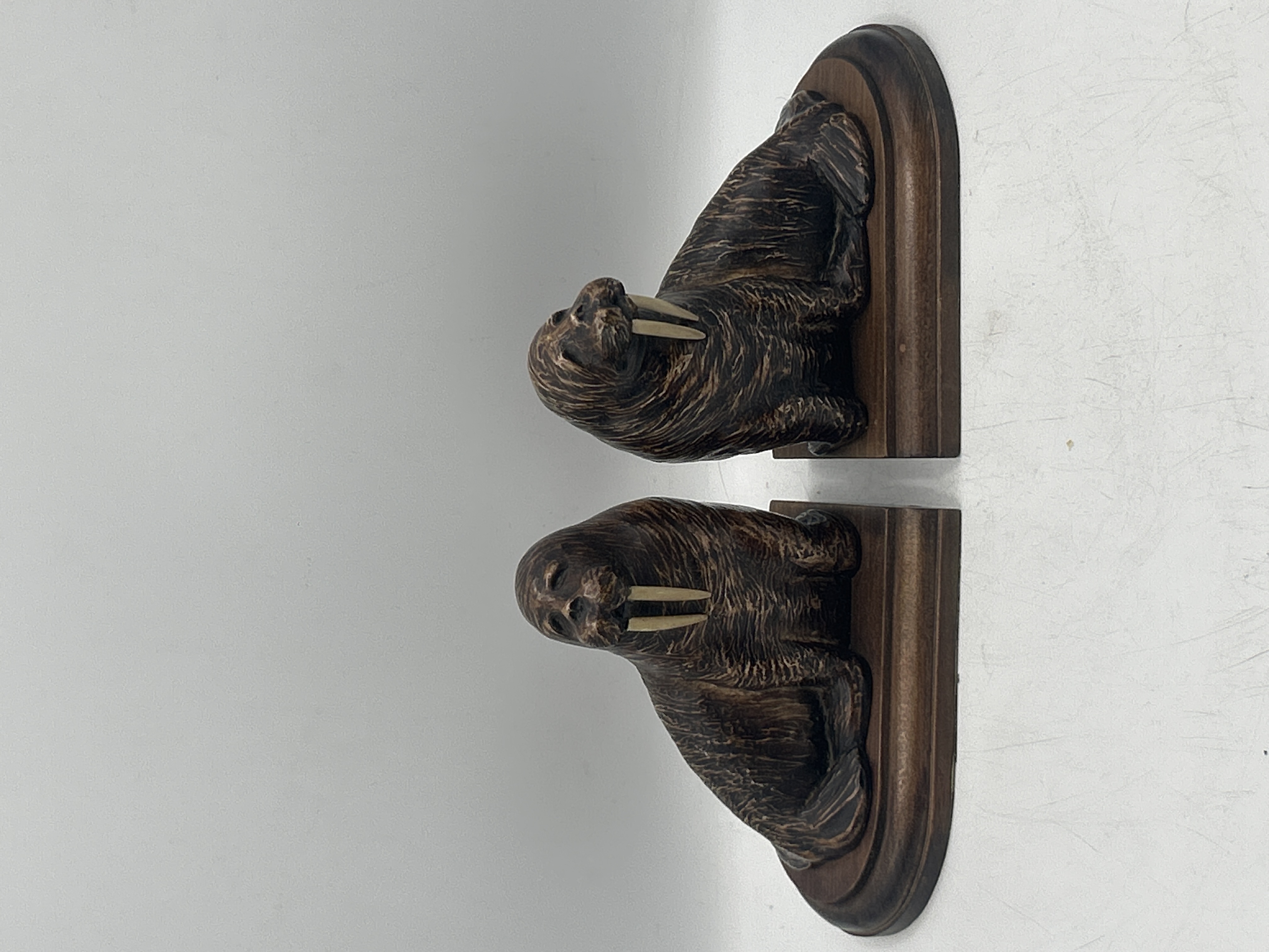 A Pair of Walrus Bookends on Wooden Bases