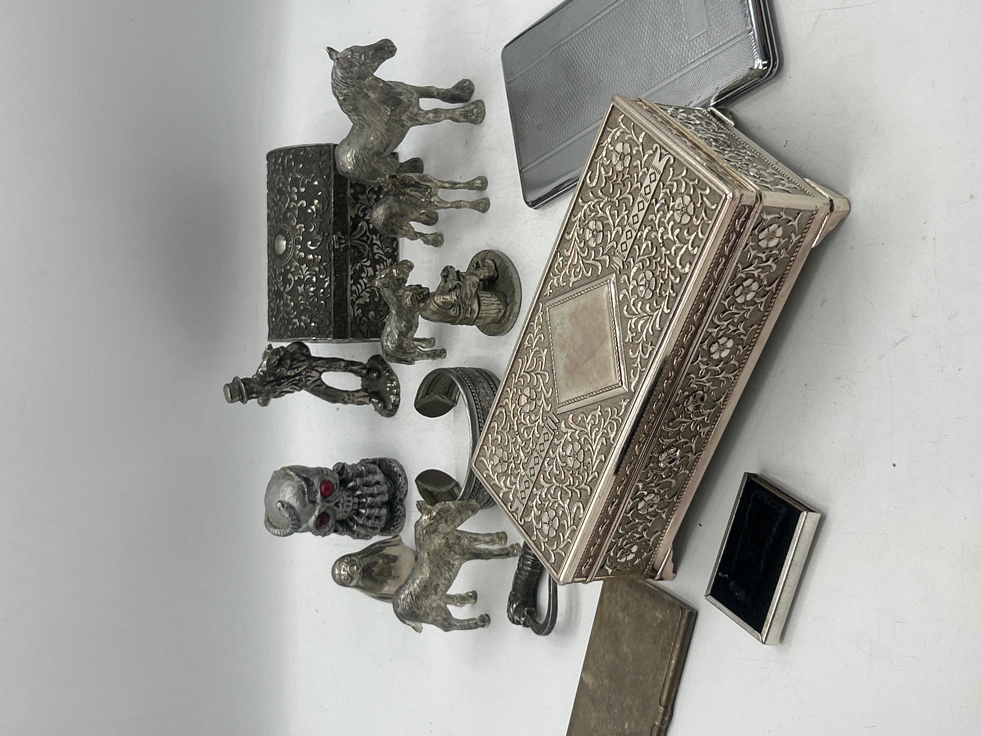 An Assortment of White Metal Decorative Items including Repousse Jewellery Boxes and Figurines