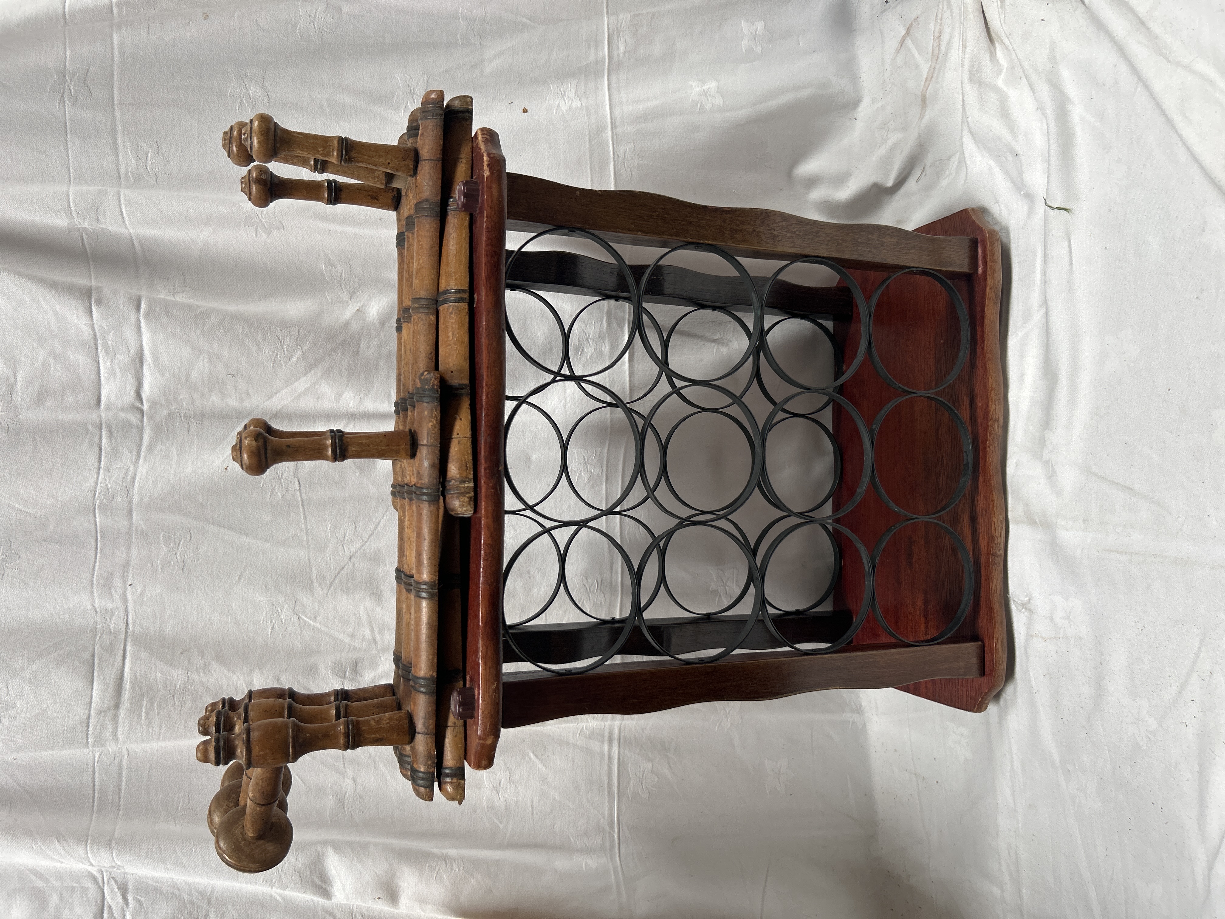 A Faux Bamboo Style Wooden and Metal Twelve Bottle Wine Rack with Integrated Accordion Peg Rack