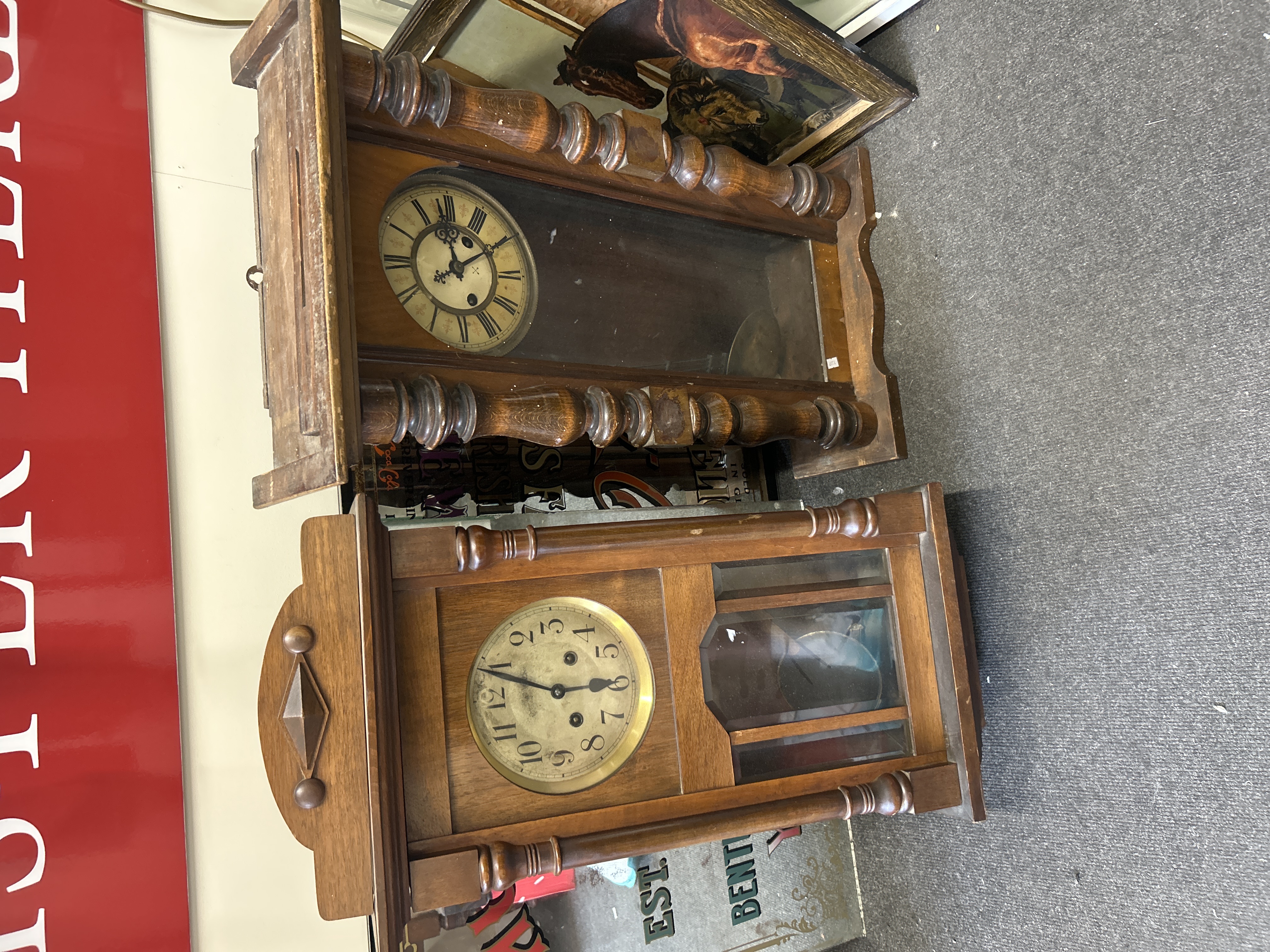 Two late 19th and early 20th-century wooden-cased mechanical wall clocks