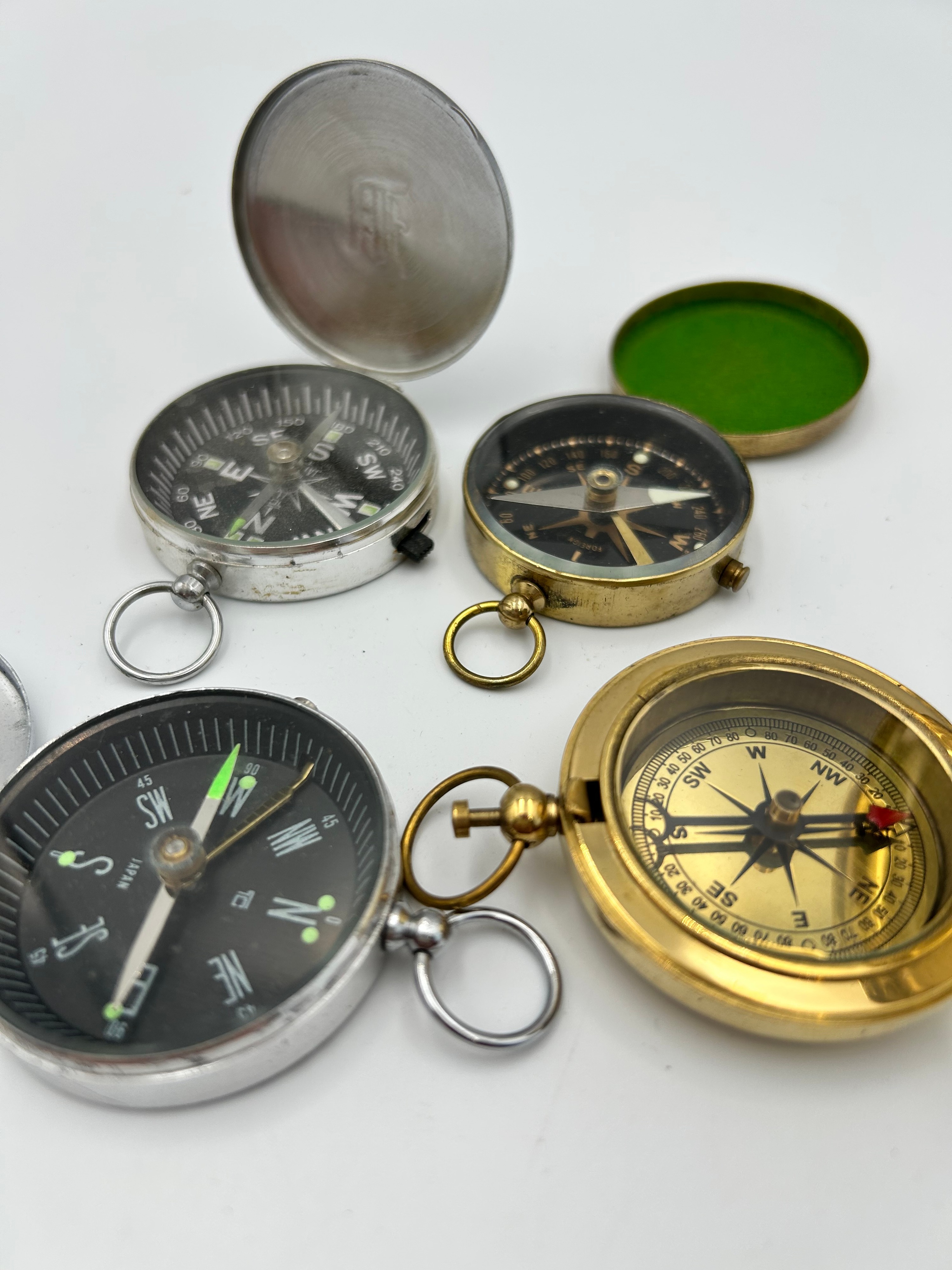 An Assortment of Vintage? Brass and White Metal Pocket Compasses