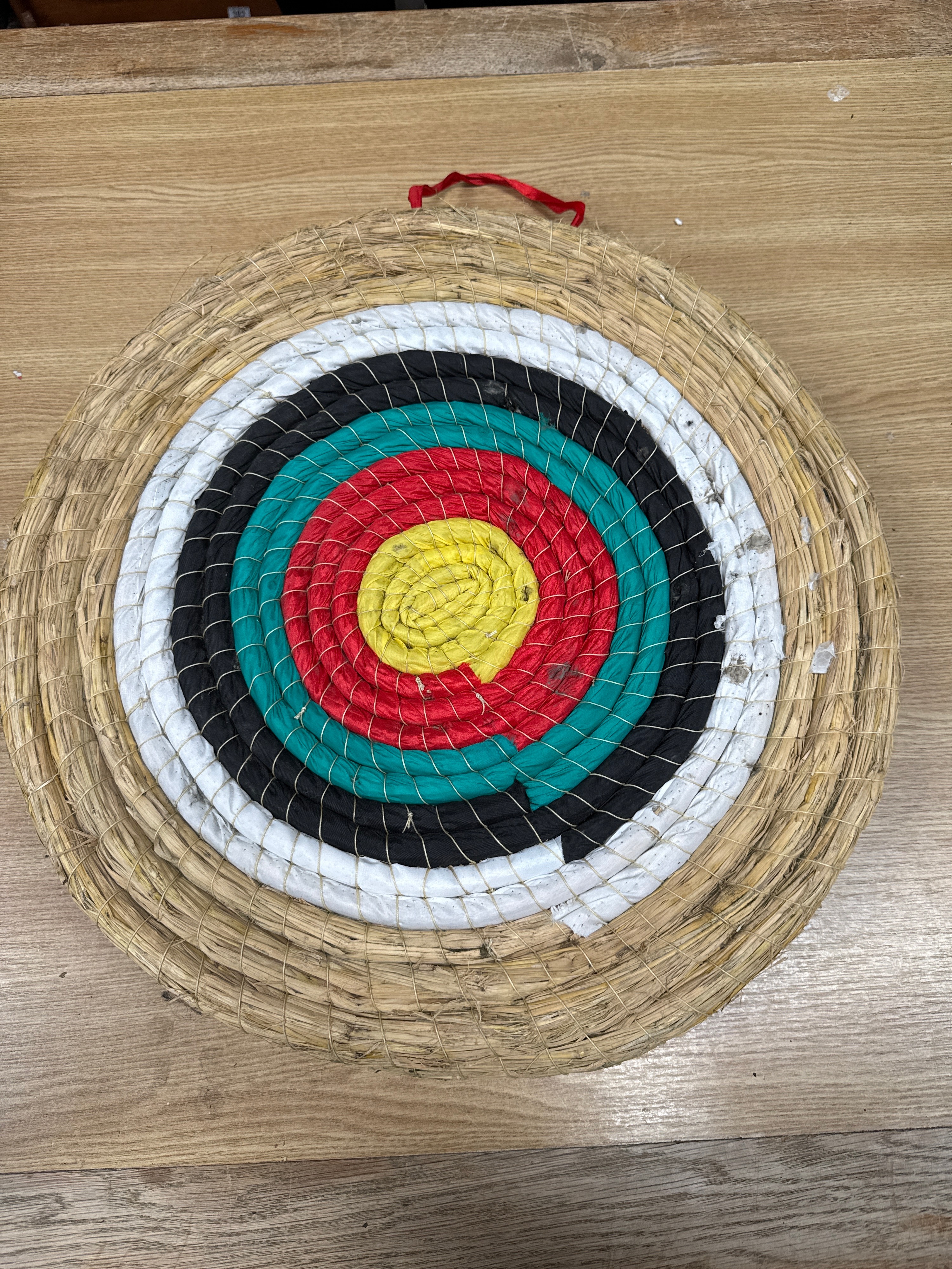 A Traditional Coiled Straw and Textile Archery Target Boss with Five Colour Rings