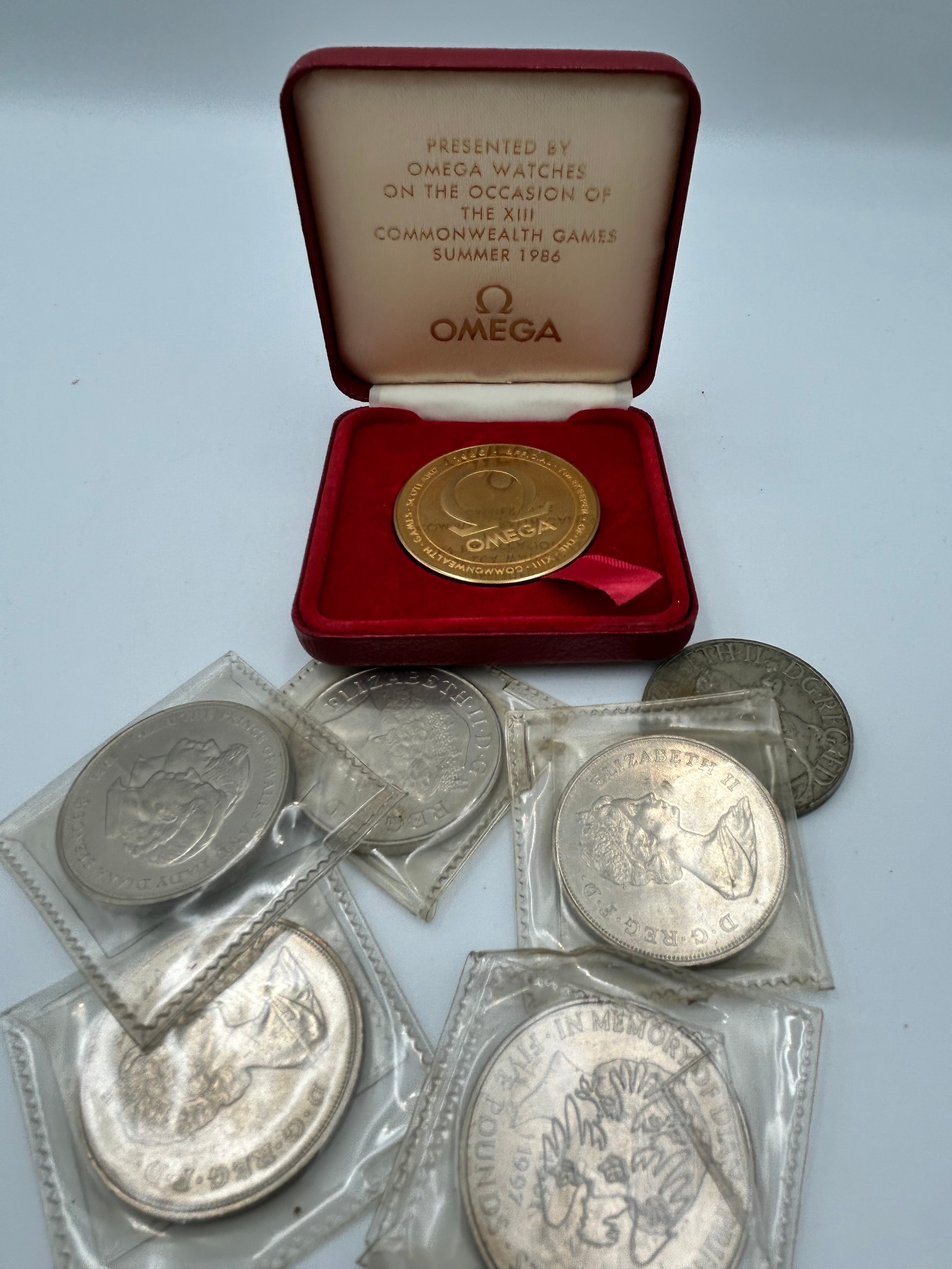 Omega Gilt Metal Effect XIII Commonwealth Games Presentation Medal, 1986 and Six Commemorative Crowns
