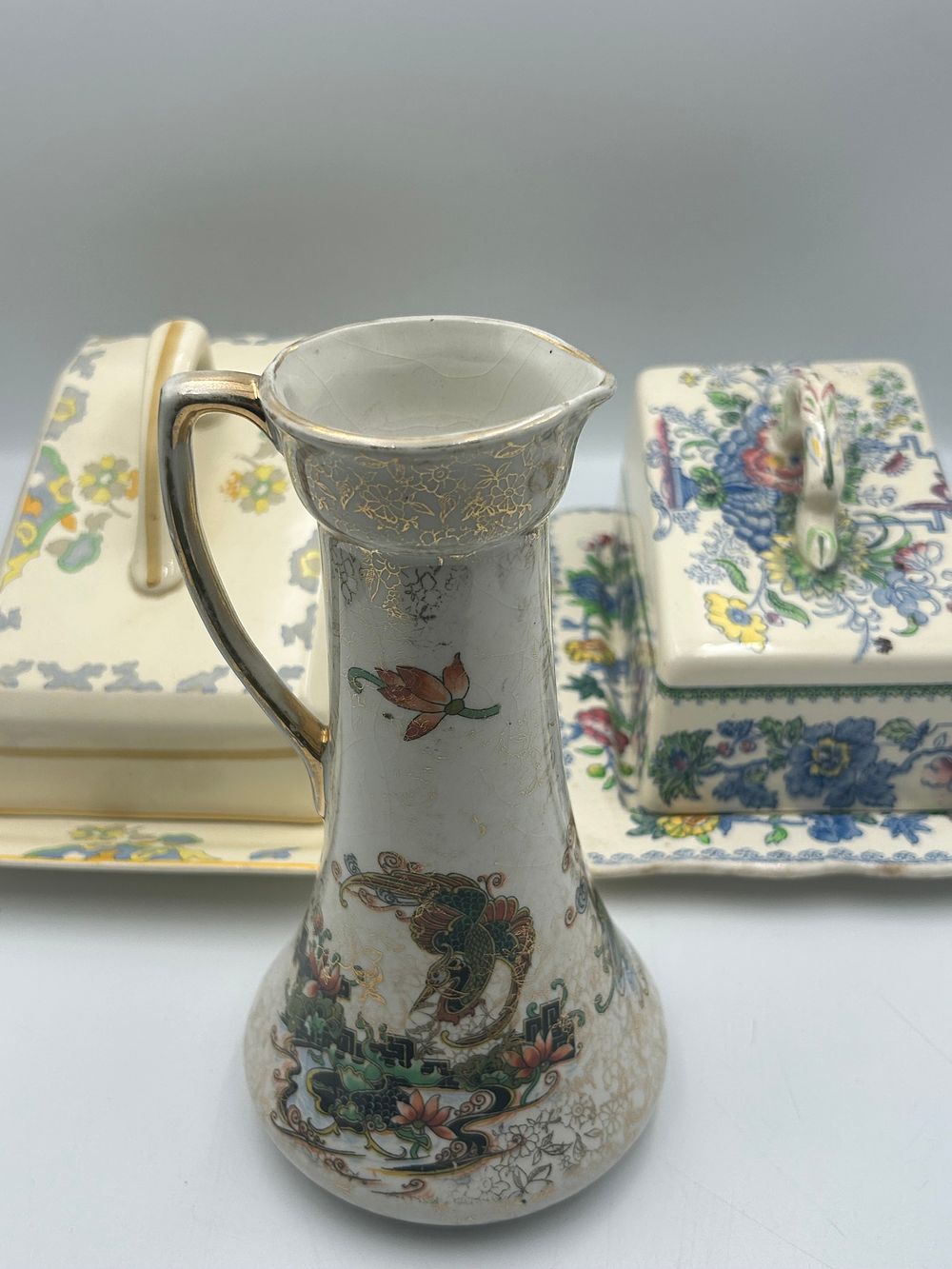 Lot 473: A Collection of Earthenware Ceramics comprising a Vase and Two Covered Cheese Dishes
