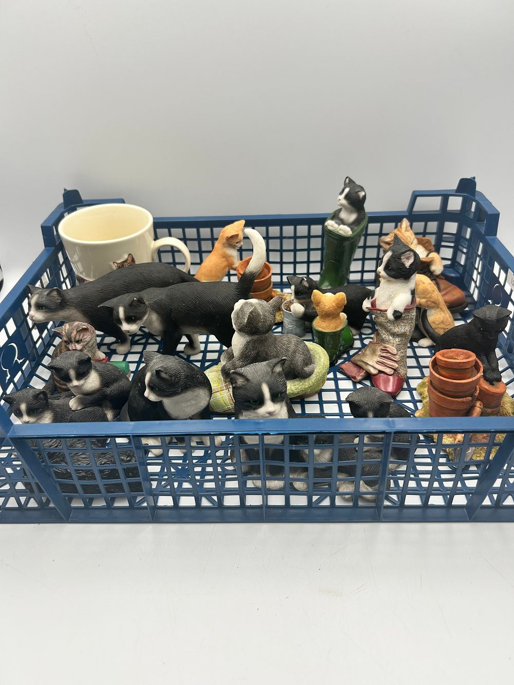 Lot 476: A Collection of Cat Themed Resin? Figurines and a Ceramic Mug