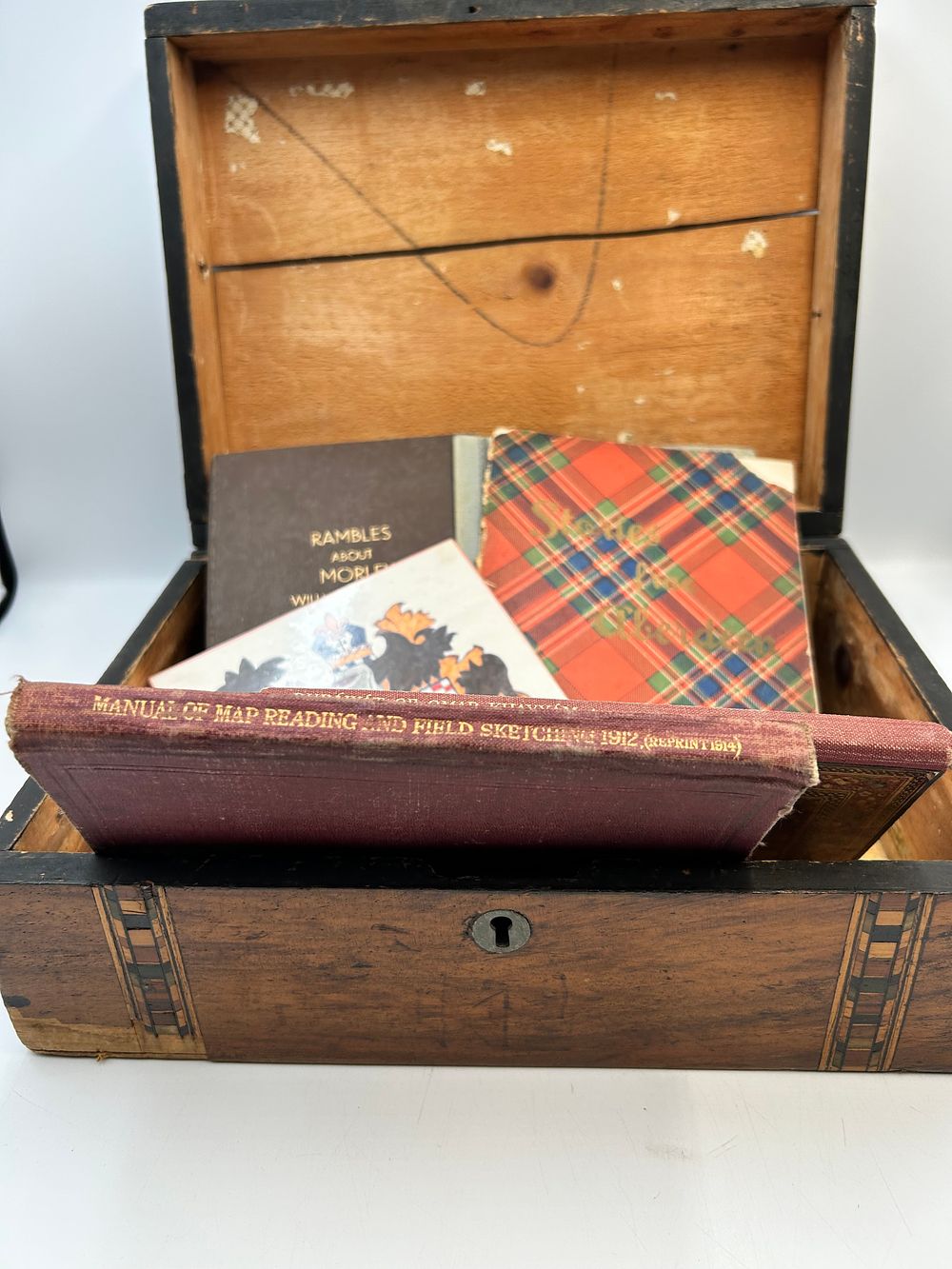 Lot 496: An Early 20th Century Wooden Marquetry Box with a Collection of Cloth-Bound Books