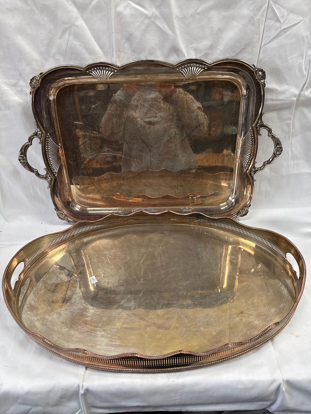 Lot 526: White Metal Rectangular Twin-Handled and Oval Gallery Serving Trays, 26" and 24"