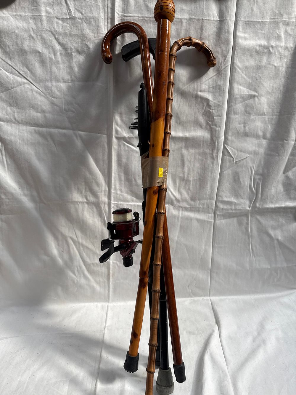 Lot 582: Four Late 20th Century Wooden and Composite? Walking Sticks and a Telescopic Fishing Rod