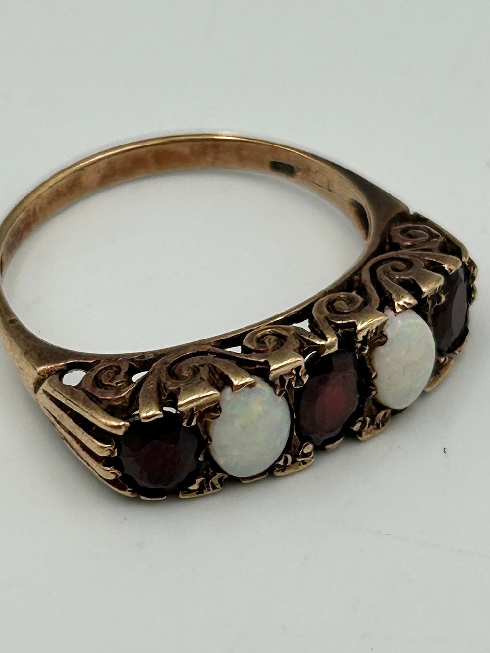 Lot 827: Late Victorian? 9 Carat Gold Five Stone Opal and Garnet Ring, Size P,  3.64g