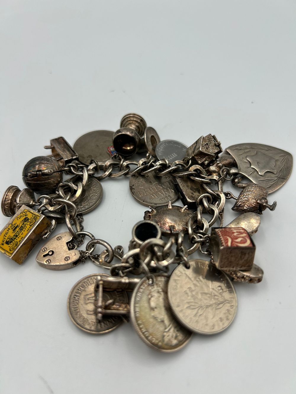 Lot 849: A Vintage Silver Loaded Charm Bracelet, 134g in total.
