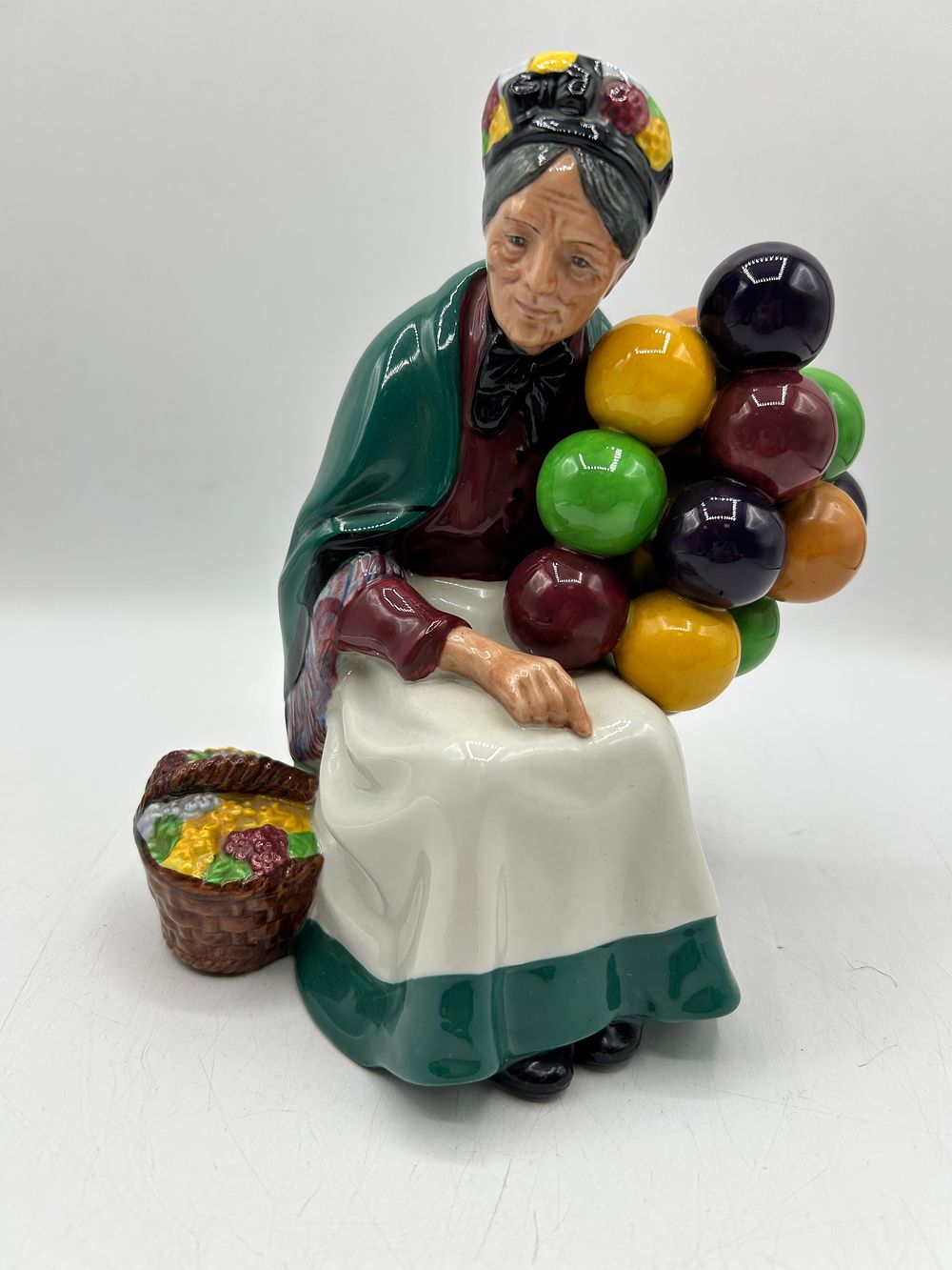 Lot 854: Royal Doulton Porcelain Figurine, The Old Balloon Seller, H.N. 1315