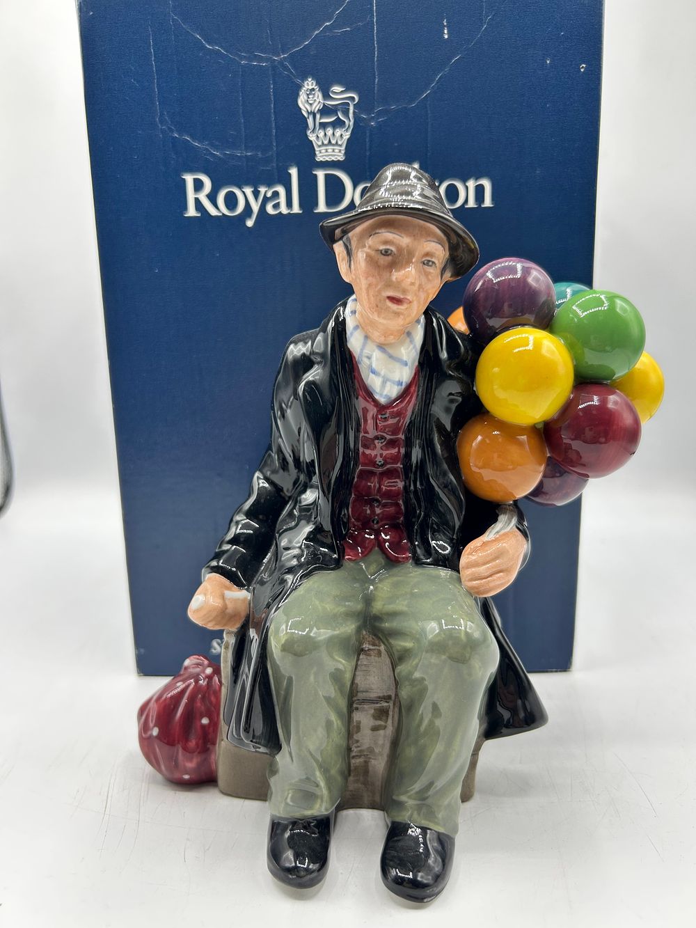 Lot 866: Royal Doulton Glazed Ceramic The Balloon Man Figurine by Leslie Harradine, 1939, HN 1954