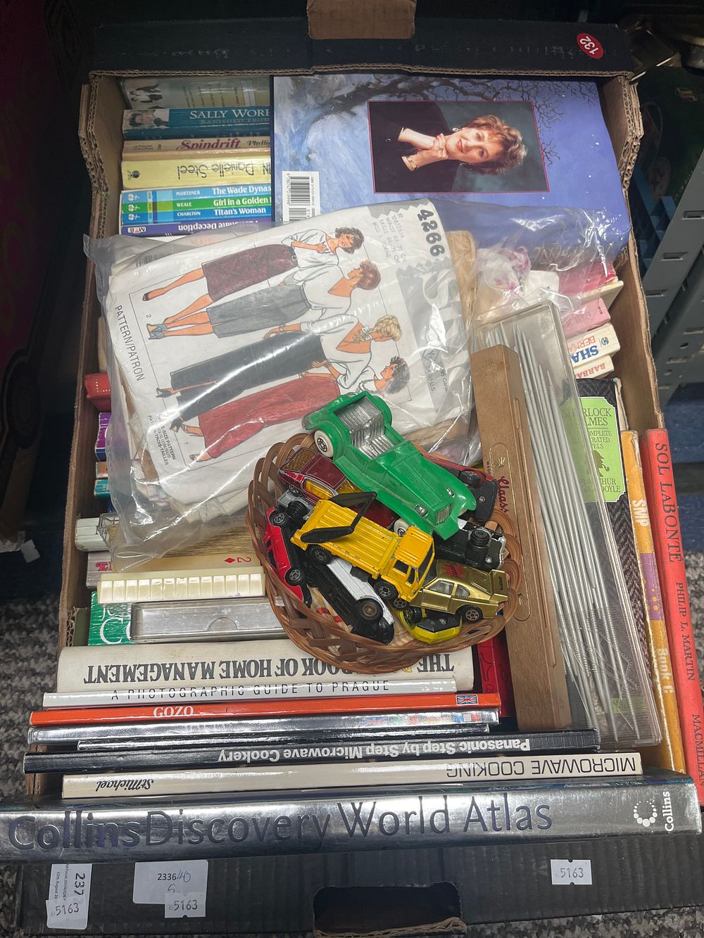 Lot 902: A Collection of Books, Simplicity Sewing Patterns, and Die-cast Toys