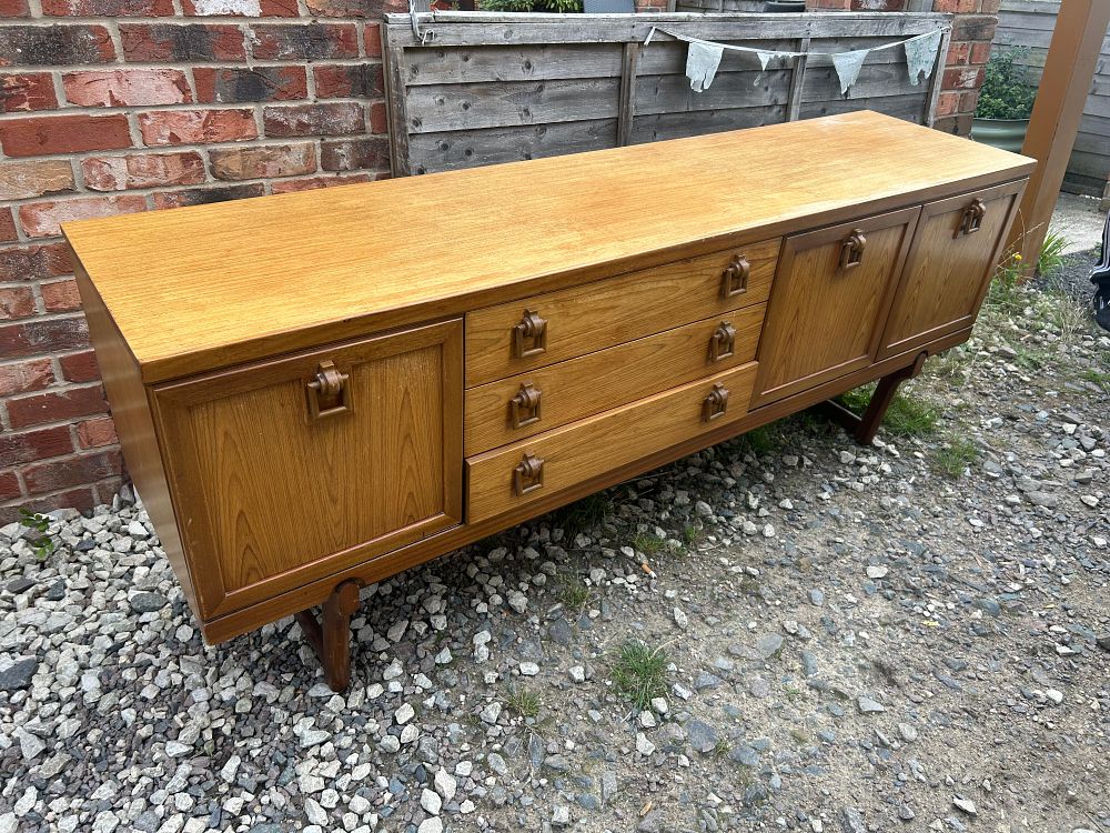 Lot 987: A British Mid-Century Teak and Teak Veneered Sideboard by Beautility?