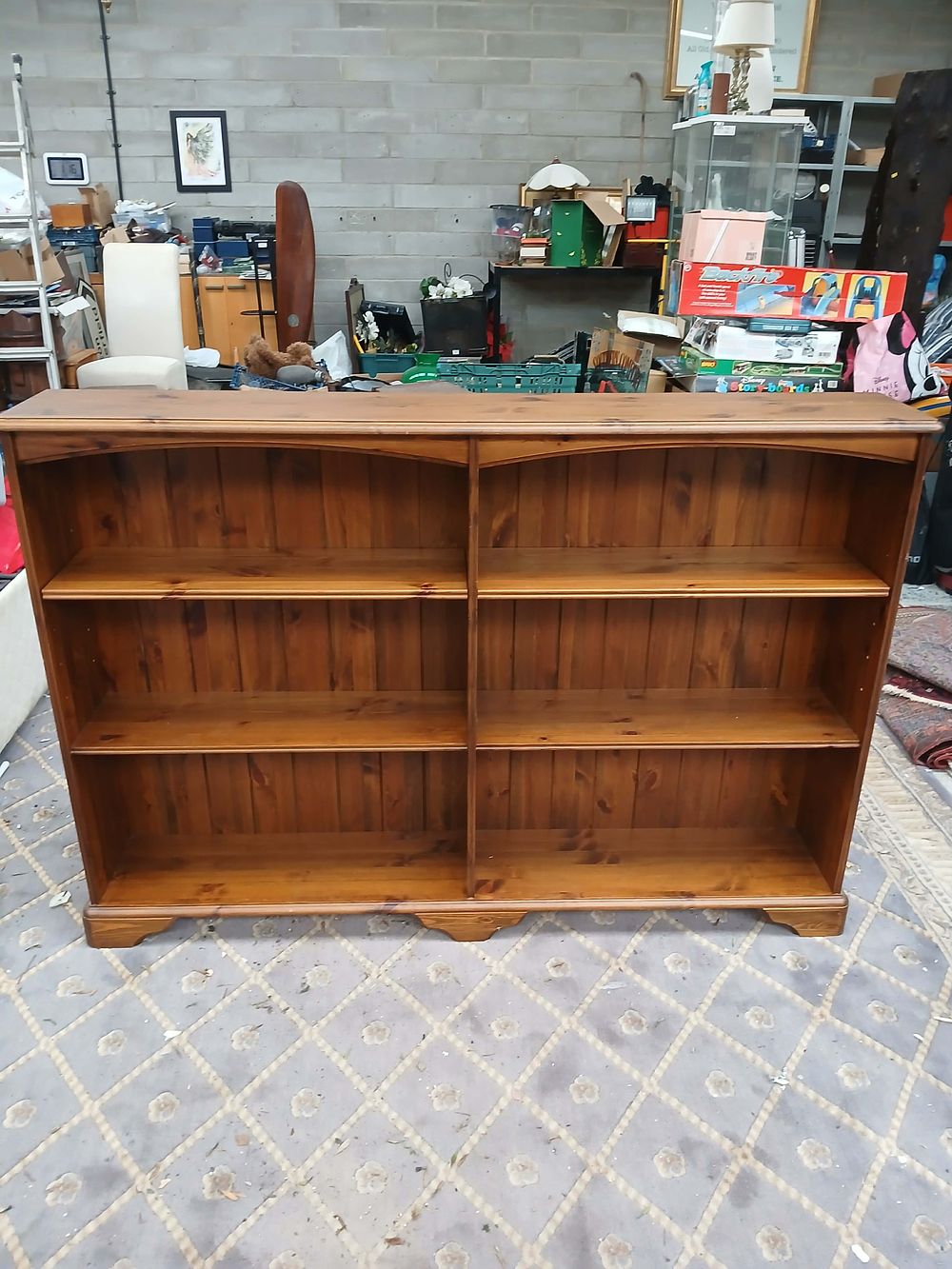 Lot 988: A low two-bay stained pine bookcase