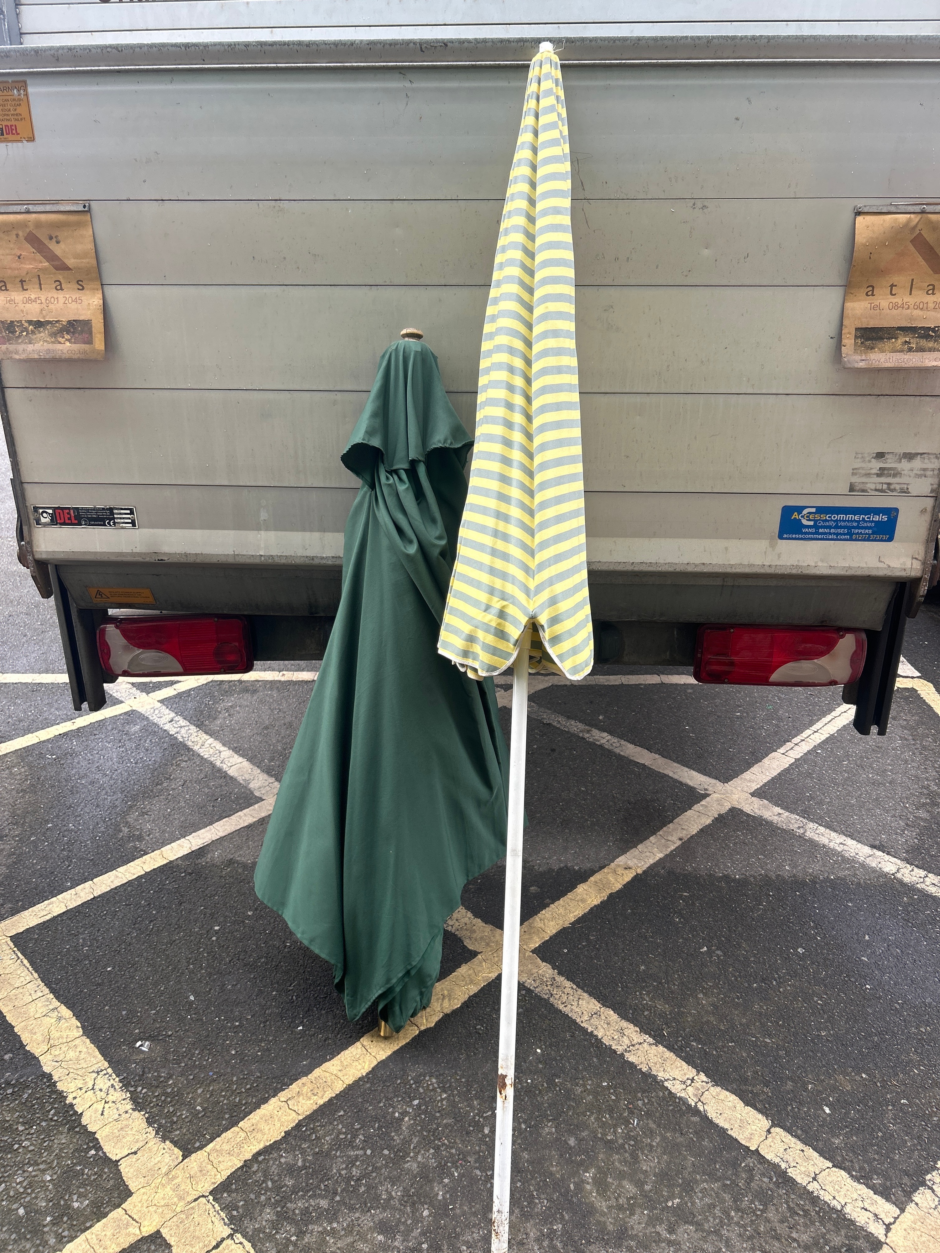 Two Garden Parasols Including Striped and Green Examples
