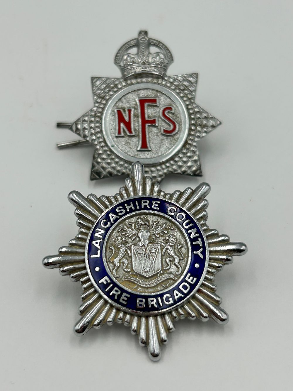 Lot 86: Two White Metal and Enamel Fire Service Cap Badges, mid-20th Century