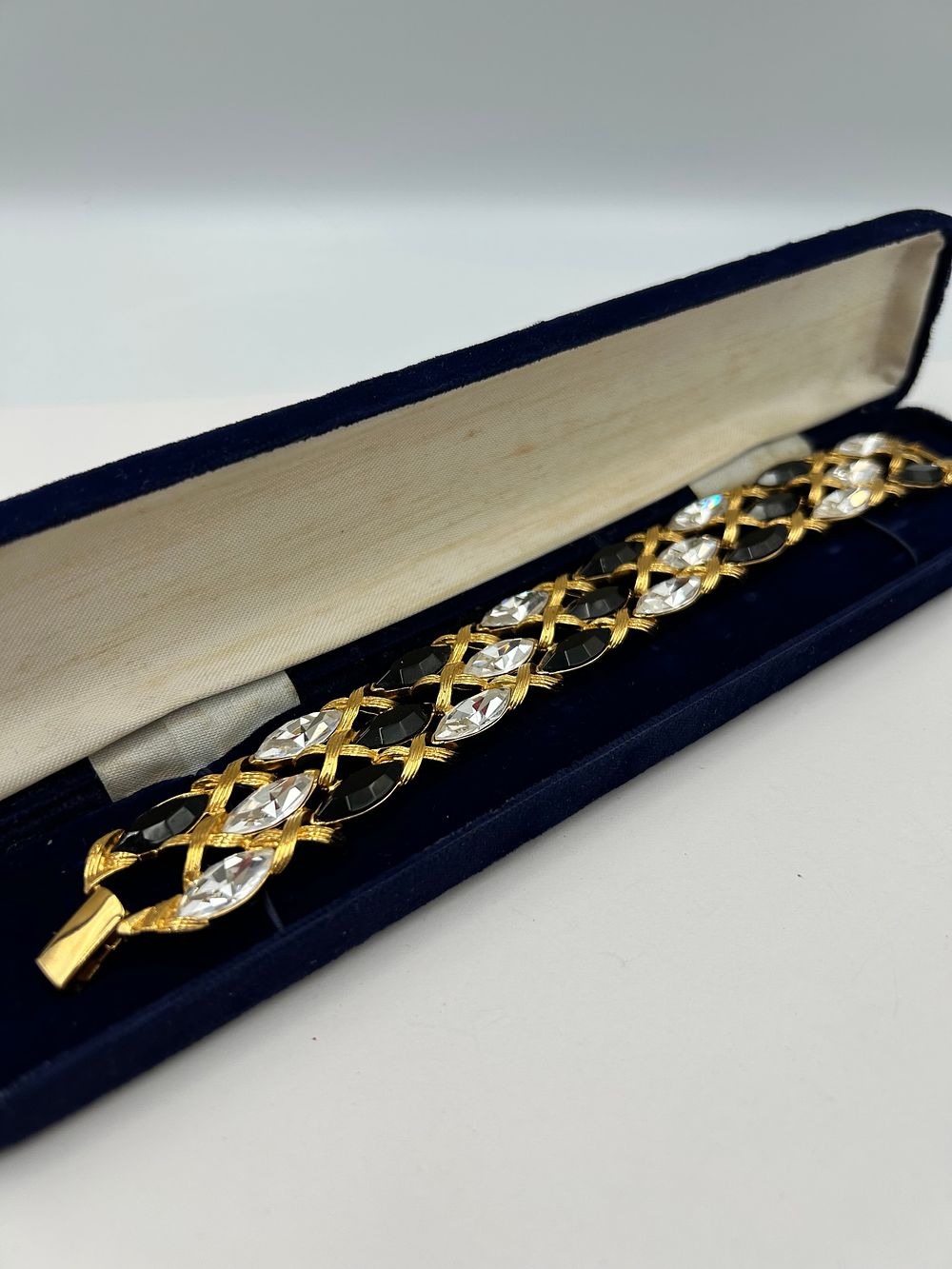 Lot 118: Napier Gilt Metal Effect Latticework Bracelet with Black and White Stones