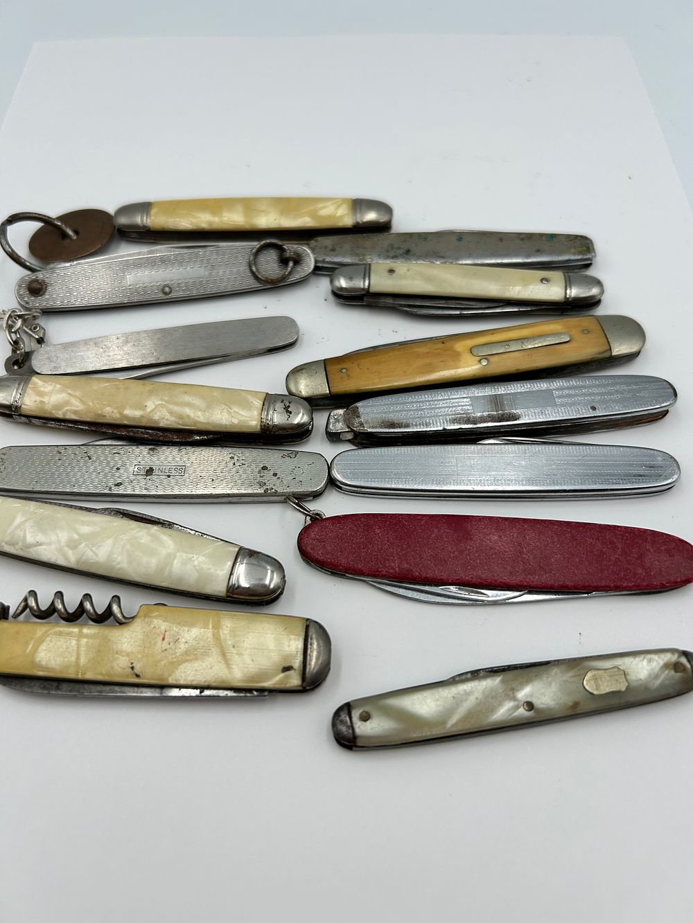 Lot 231: An Assortment of Vintage White Metal and Imitation Pearl? Pocket Knives