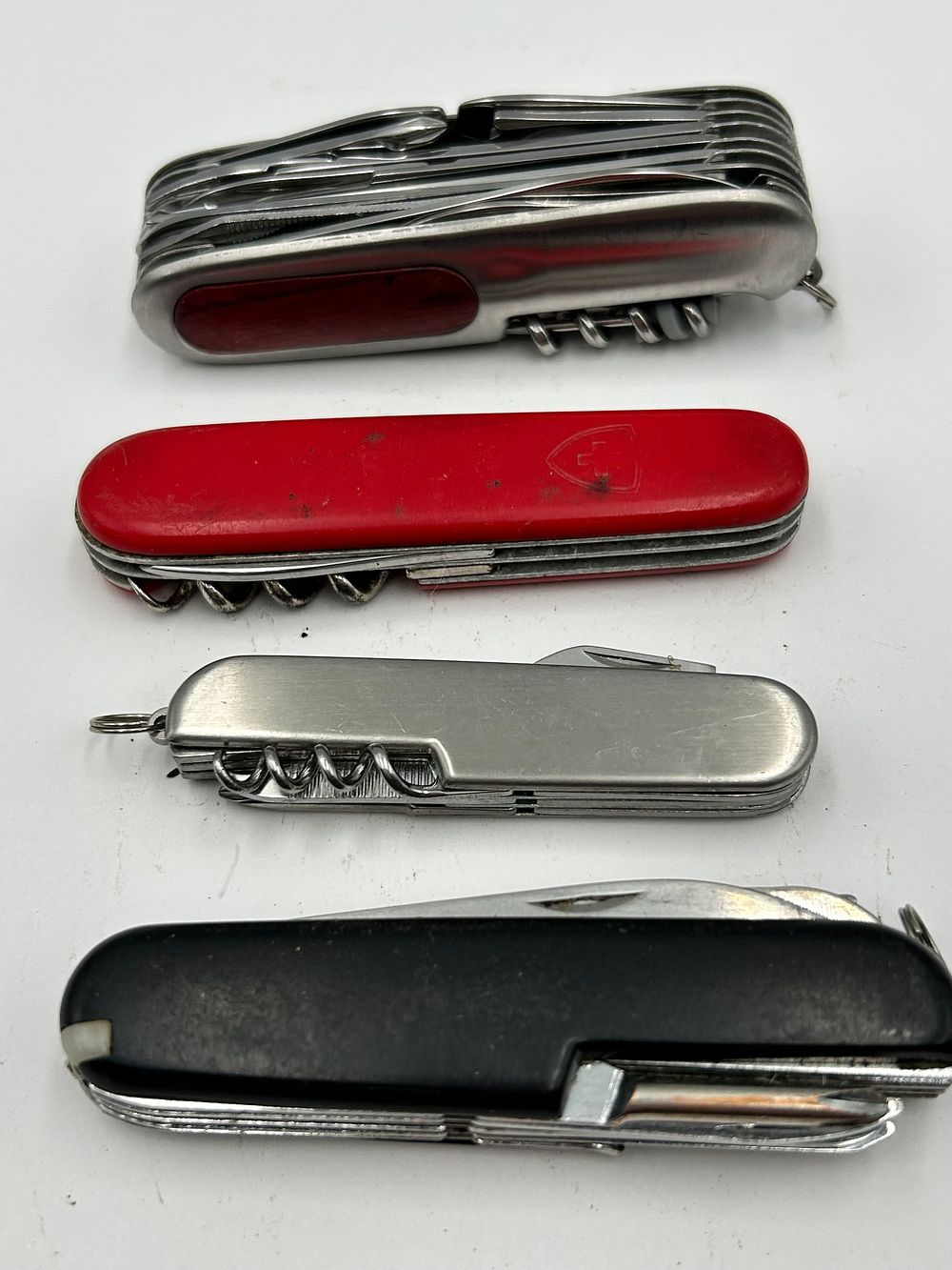 Lot 241: An Assortment of Multi-Tool Folding Pocket Knives Including Wenger?