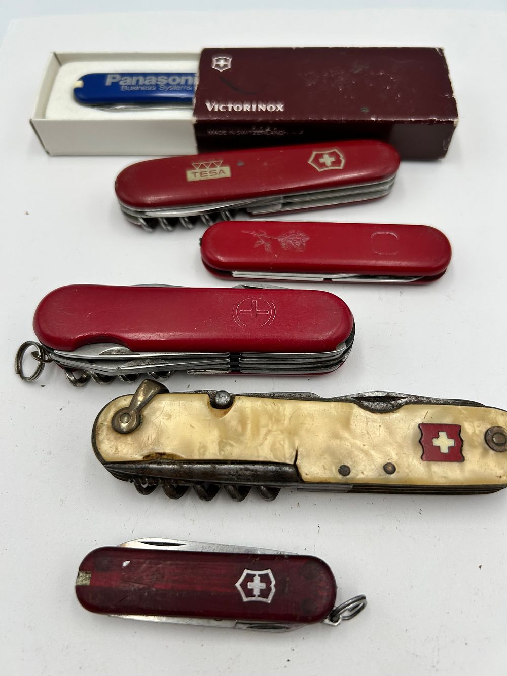 Lot 248: A Collection of Victorinox and Wenger Red and Celluloid? Multi-Tool Pocket Knives