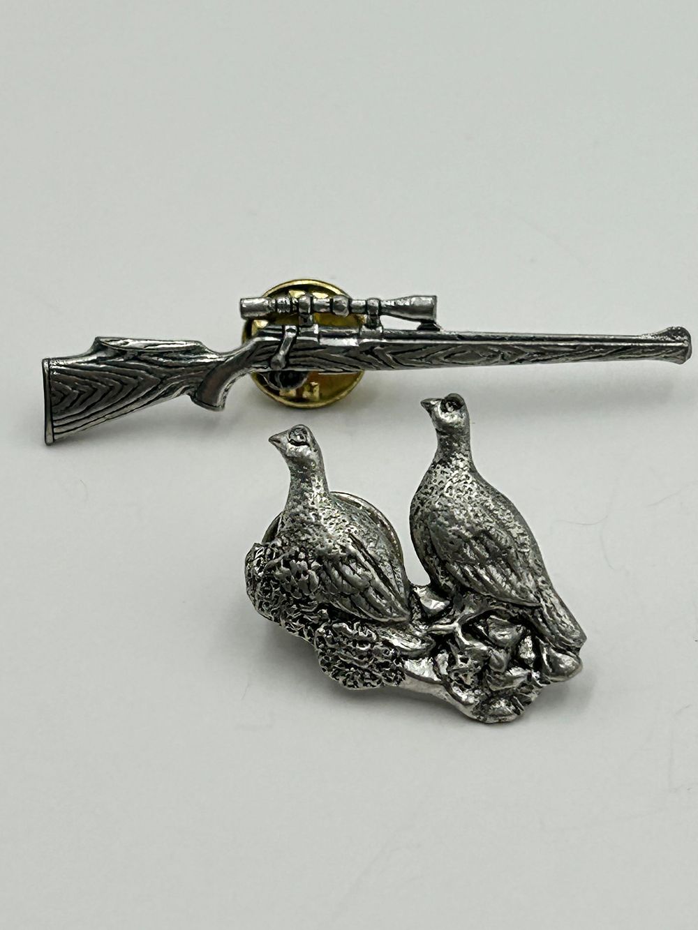 Lot 252: A Pair of White Metal Sporting Lapel Pins by J. S. Brown?