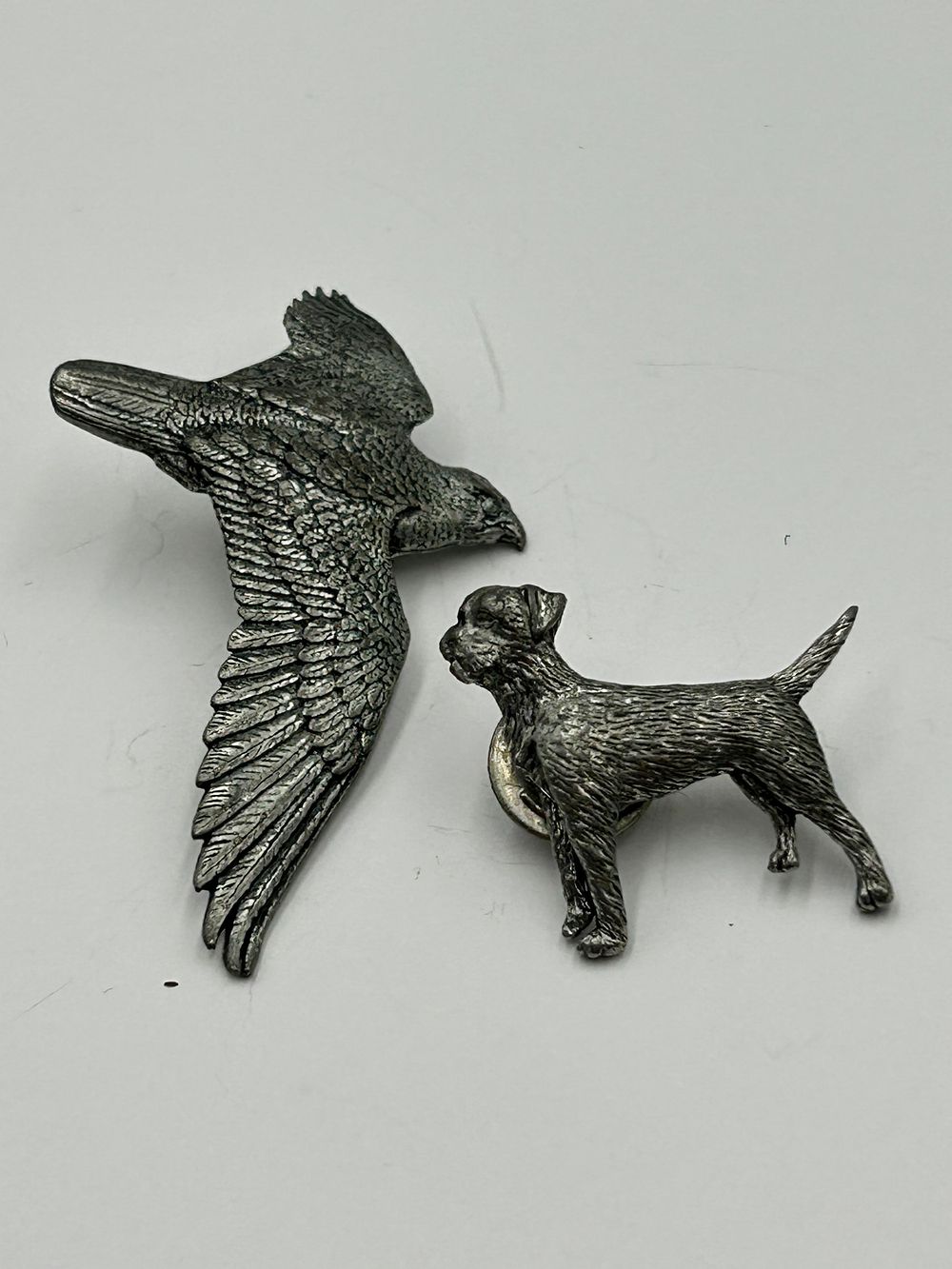 Lot 254: Two Pewter Brooches Depicting a Bird of Prey and a Terrier