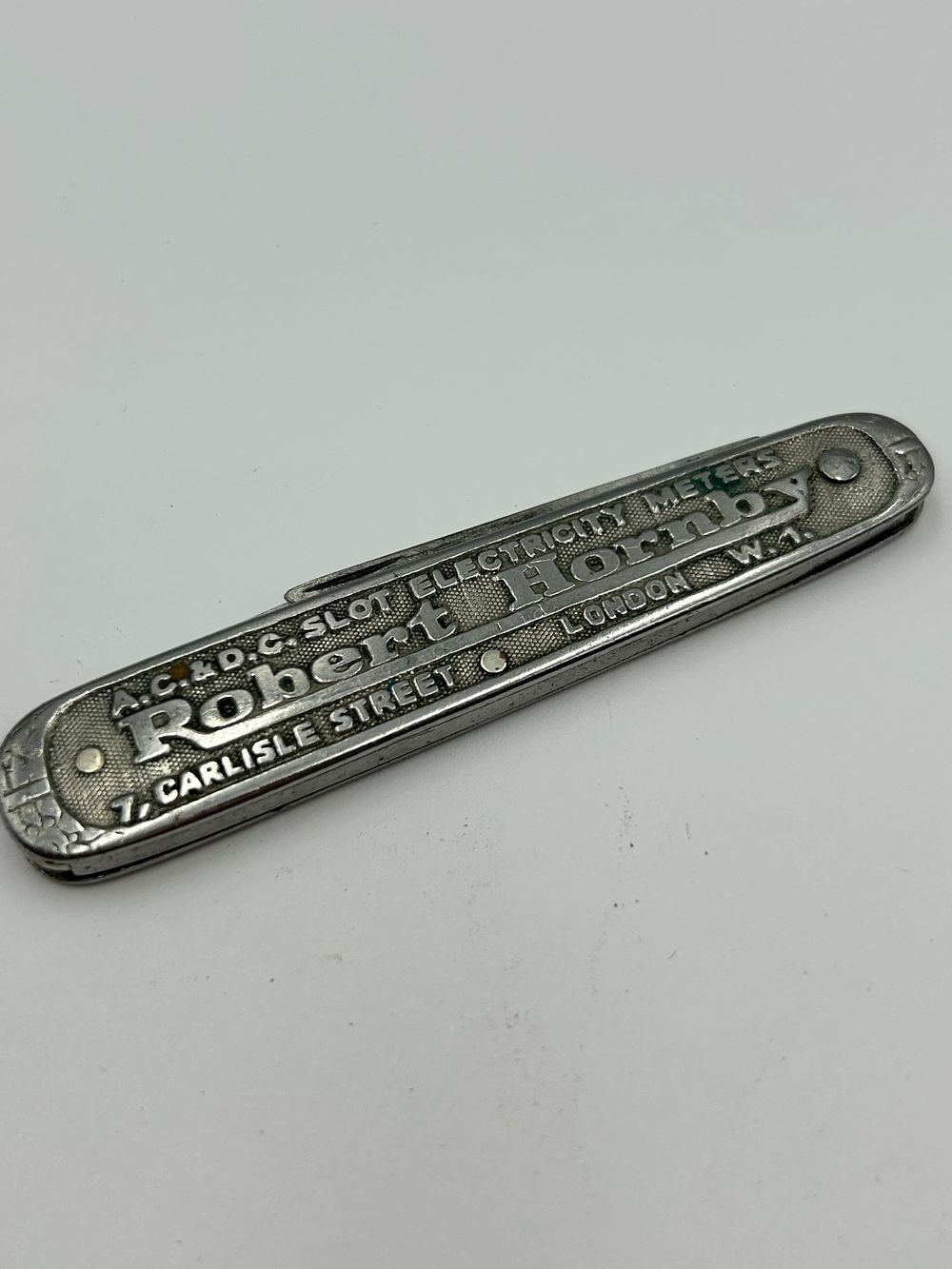 Lot 266: Vintage White Metal Advertising Penknife for Robert Hornby & Co Ltd
