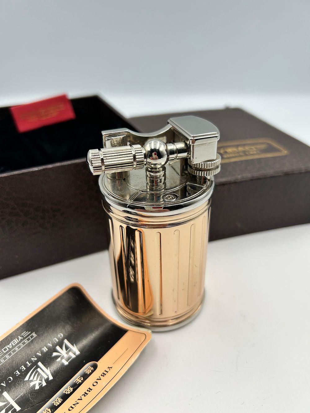 Lot 279: Yibao Gilt-Metal Effect and Polished Chrome? Table Lighter
