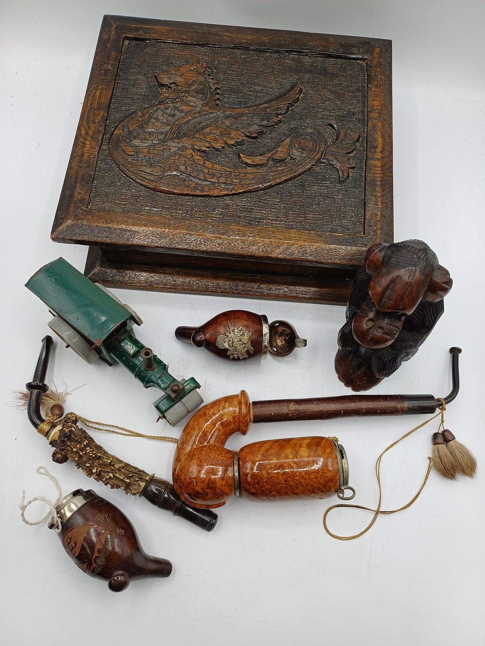 Lot 353: A Collection of Black Forest Style Wood Carvings and Smoking Pipes