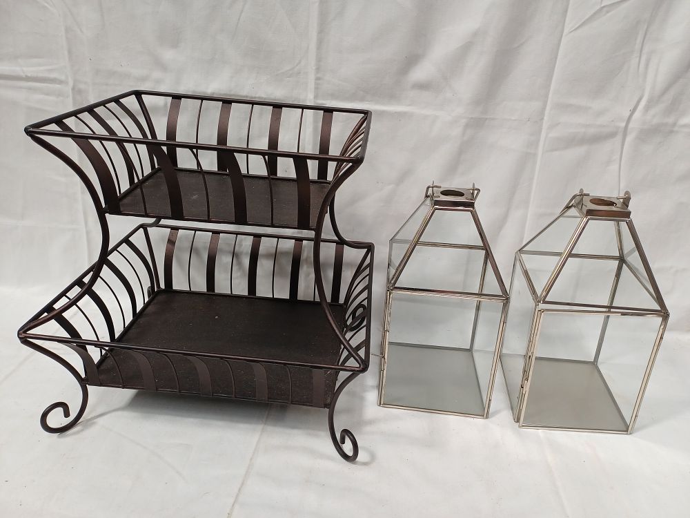 Lot 432: A Metal Two-Tiered Rectangular Storage Basket and a Pair of Silver-Tone Effect Glass Lanterns