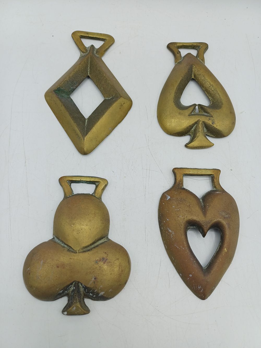 Lot 557: A Set of Four Antique Brass Horse Brasses Representing Playing Card Suits