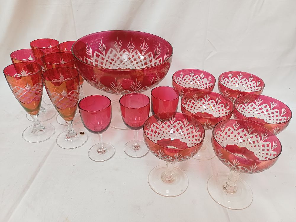 Lot 580: A Set of Bohemian? Cranberry Cut to Clear Crystal Tableware