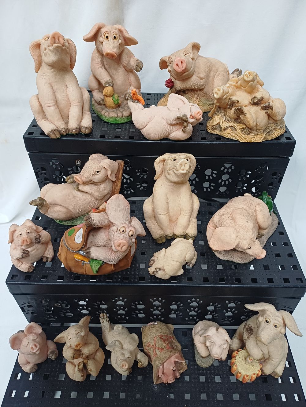 Lot 593: A Collection of Cast Resin? Pig Figurines in the Rural Style