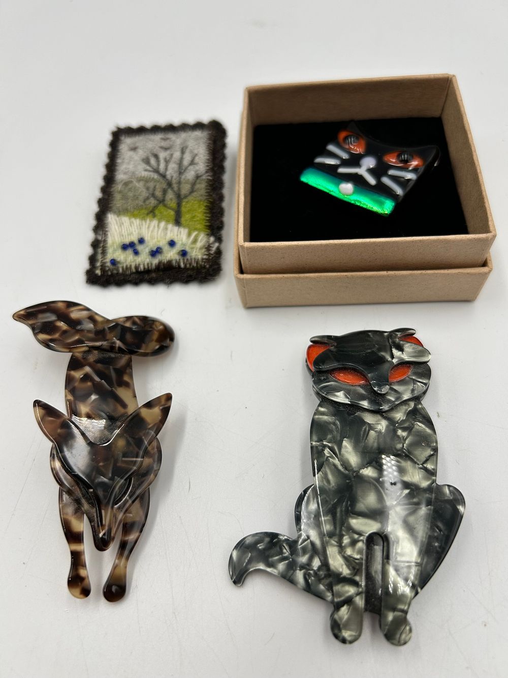 Lot 631: A Collection of Cat and Animal Themed Brooches, Resin?