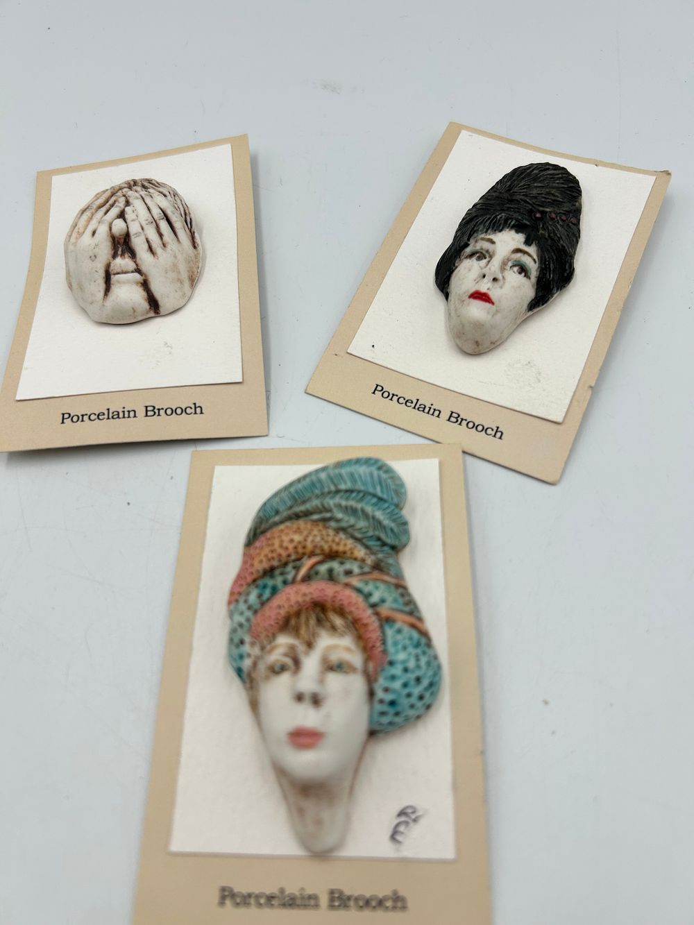 Lot 633: A Trio of Porcelain Brooches by Ruth Charlton, Cumbria