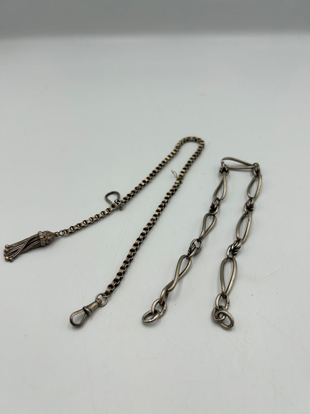 Lot 638: Two Victorian? Silver and  White Metal Fancy Watch Chains, one with Tassel