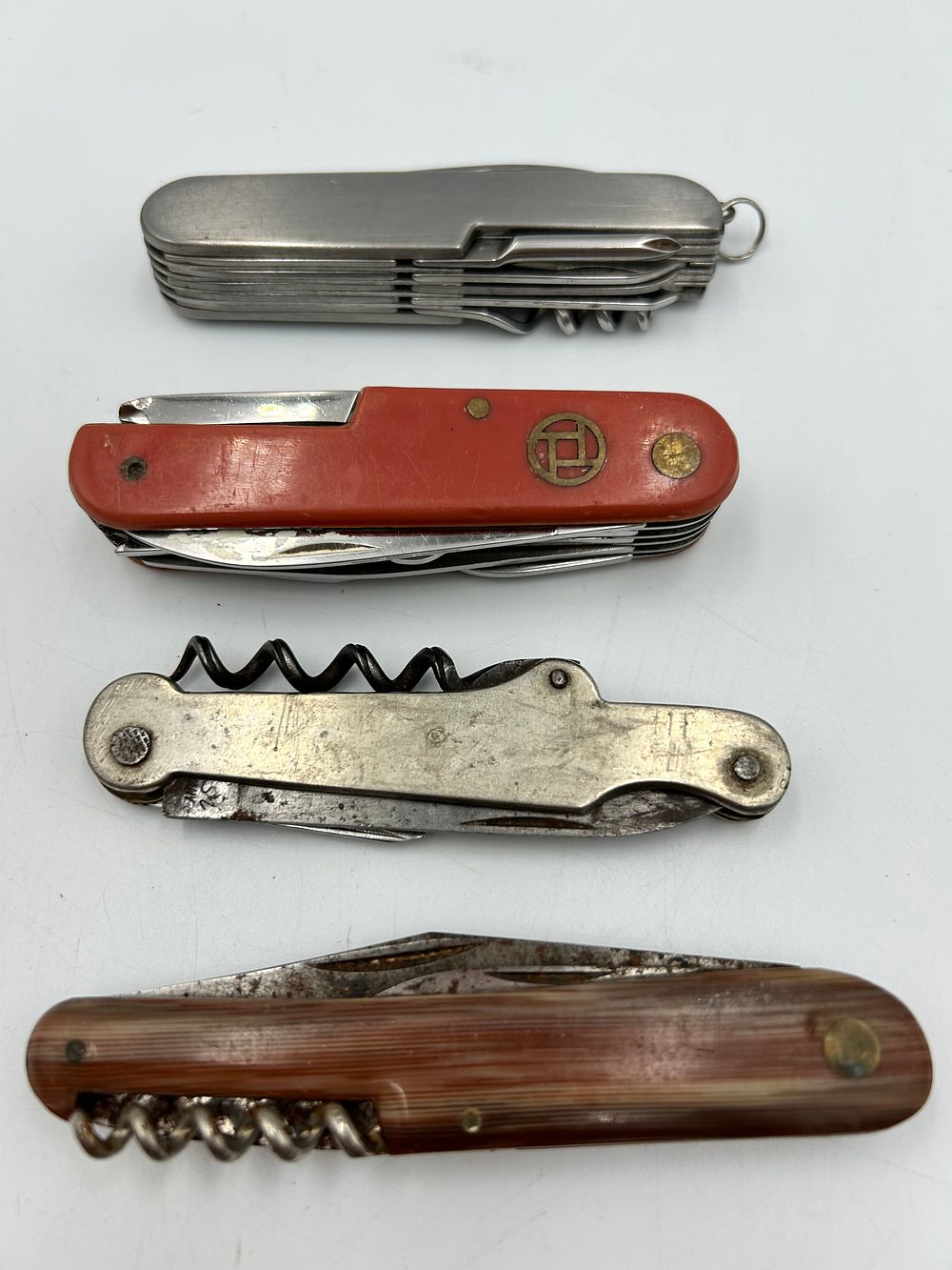 Lot 648: An Assortment of Steel and Composition Multi-Tool Pocket Knives